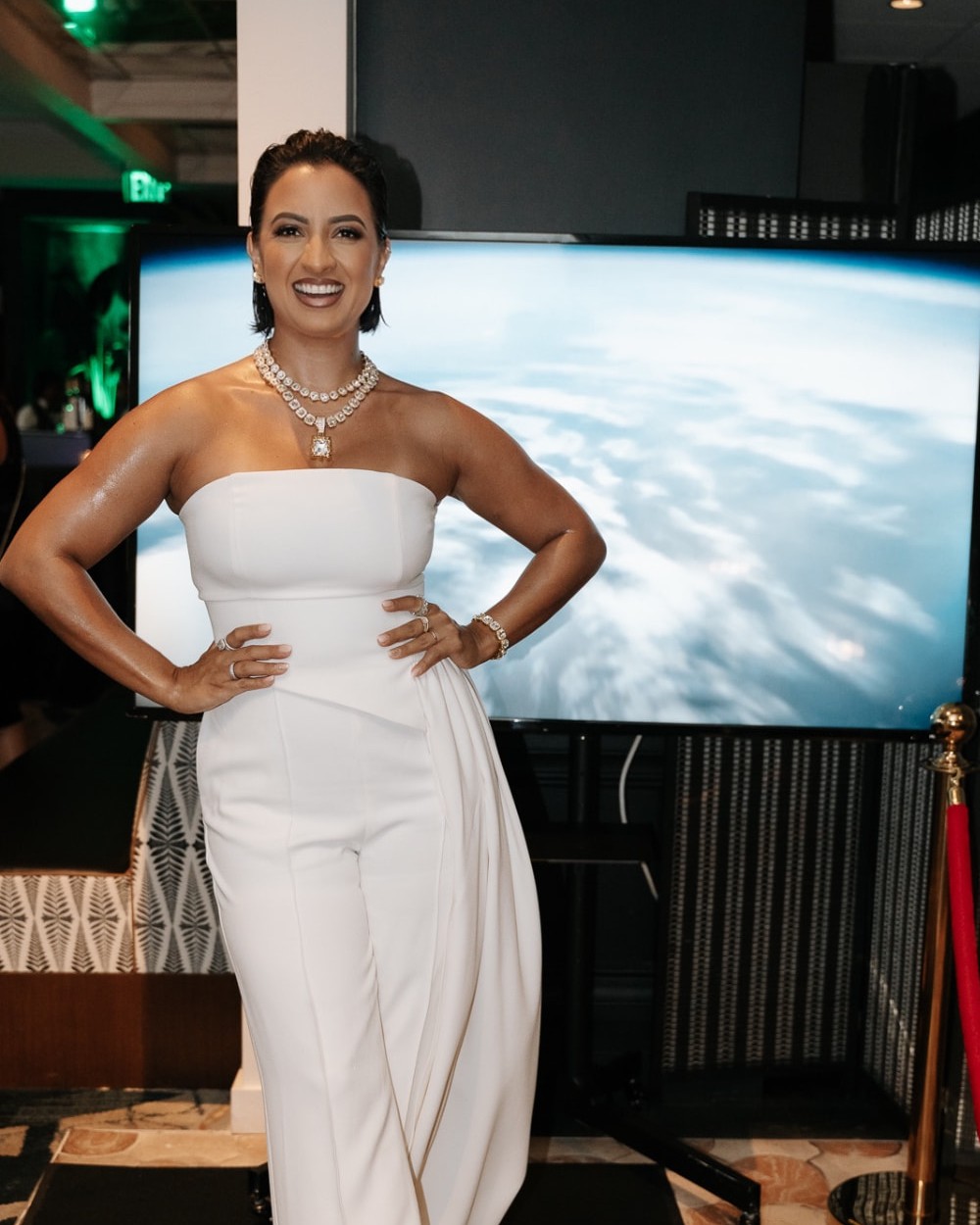 Debora Mendonça in an ivory jumpsuit and statement necklace at an evening gala