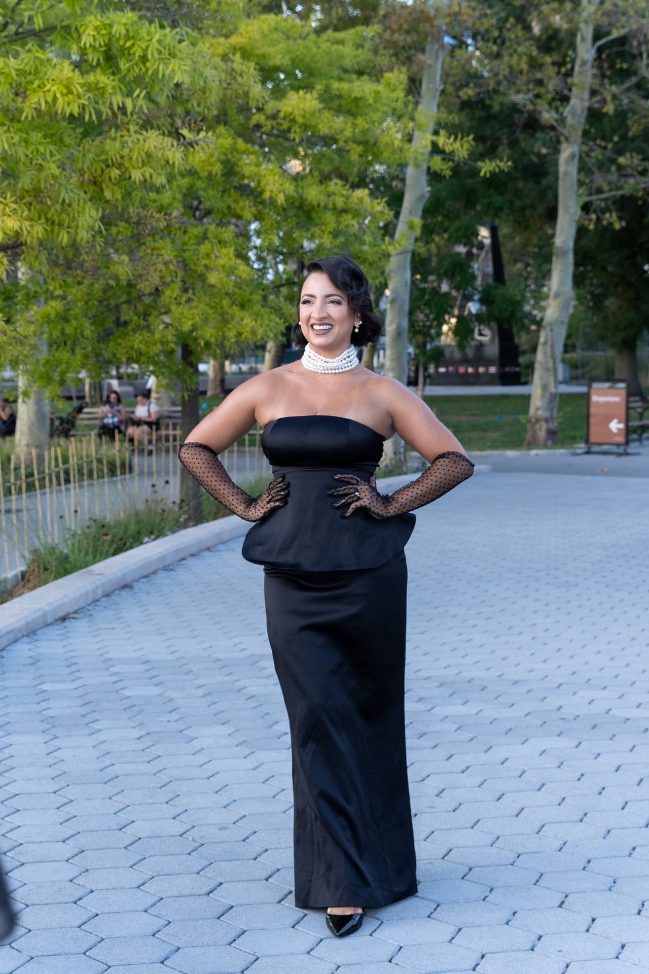 Debora Mendonça, owner of My Luxury Closet, wearing a black gown with a pearl collar